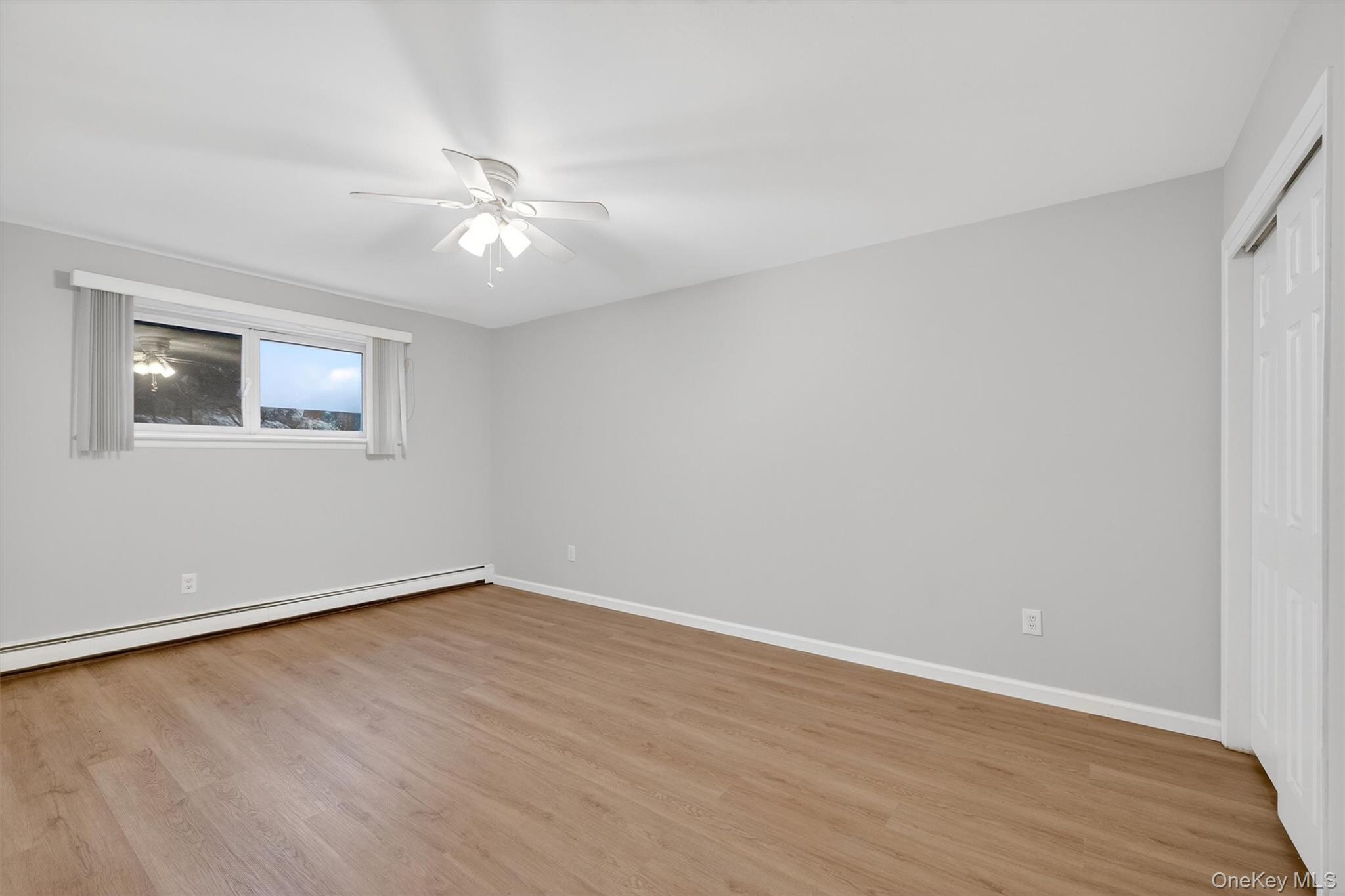 14 Scenic Drive, Unit 14T Croton-on-Hudson, NY 10520 - Photo 23 of 29 a view of an empty room with wooden floor and a window