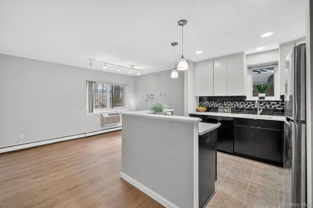 a kitchen with a refrigerator and a stove top oven