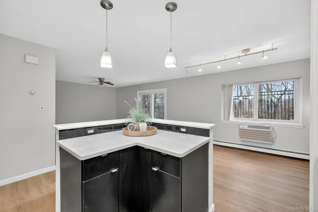 a kitchen with a sink a counter space and wooden floor