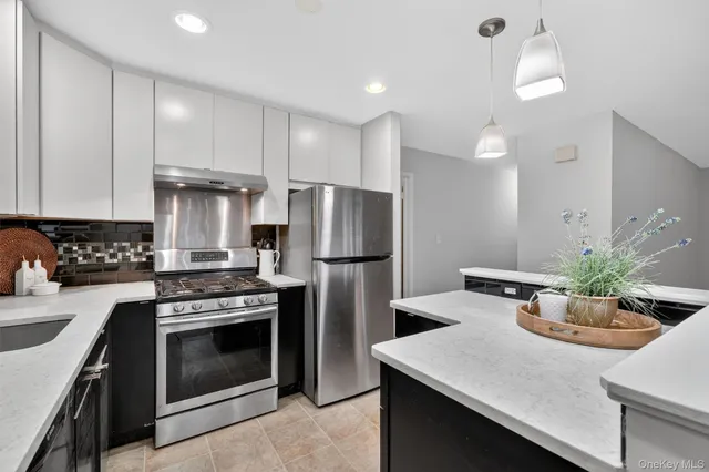 a kitchen with a stove a refrigerator and a sink
