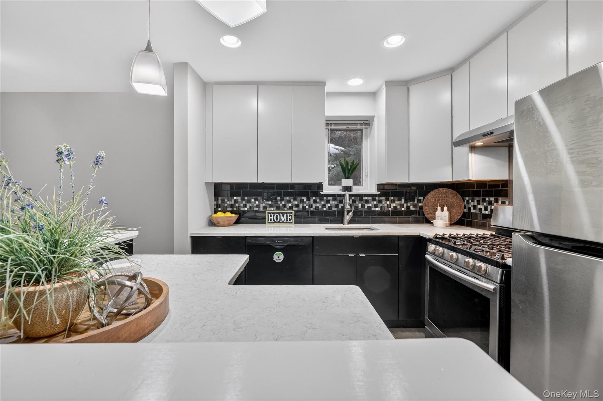 14 Scenic Drive, Unit 14T Croton-on-Hudson, NY 10520 - Photo 8 of 29 a kitchen with stainless steel appliances granite countertop a sink a stove a refrigerator cabinets and living room view