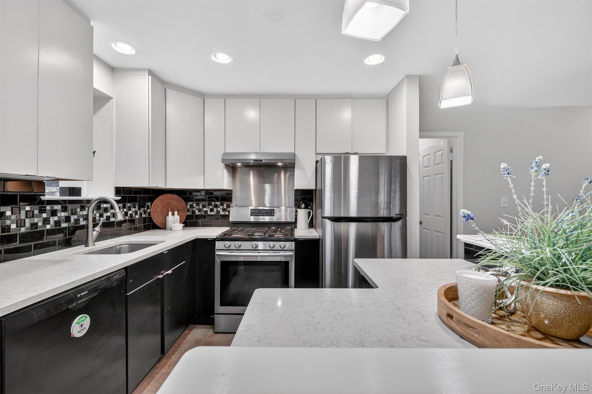 14 Scenic Drive, Unit 14T Croton-on-Hudson, NY 10520 - Photo 9 of 29 a kitchen with stainless steel appliances kitchen island granite countertop a refrigerator a sink a stove and cabinets