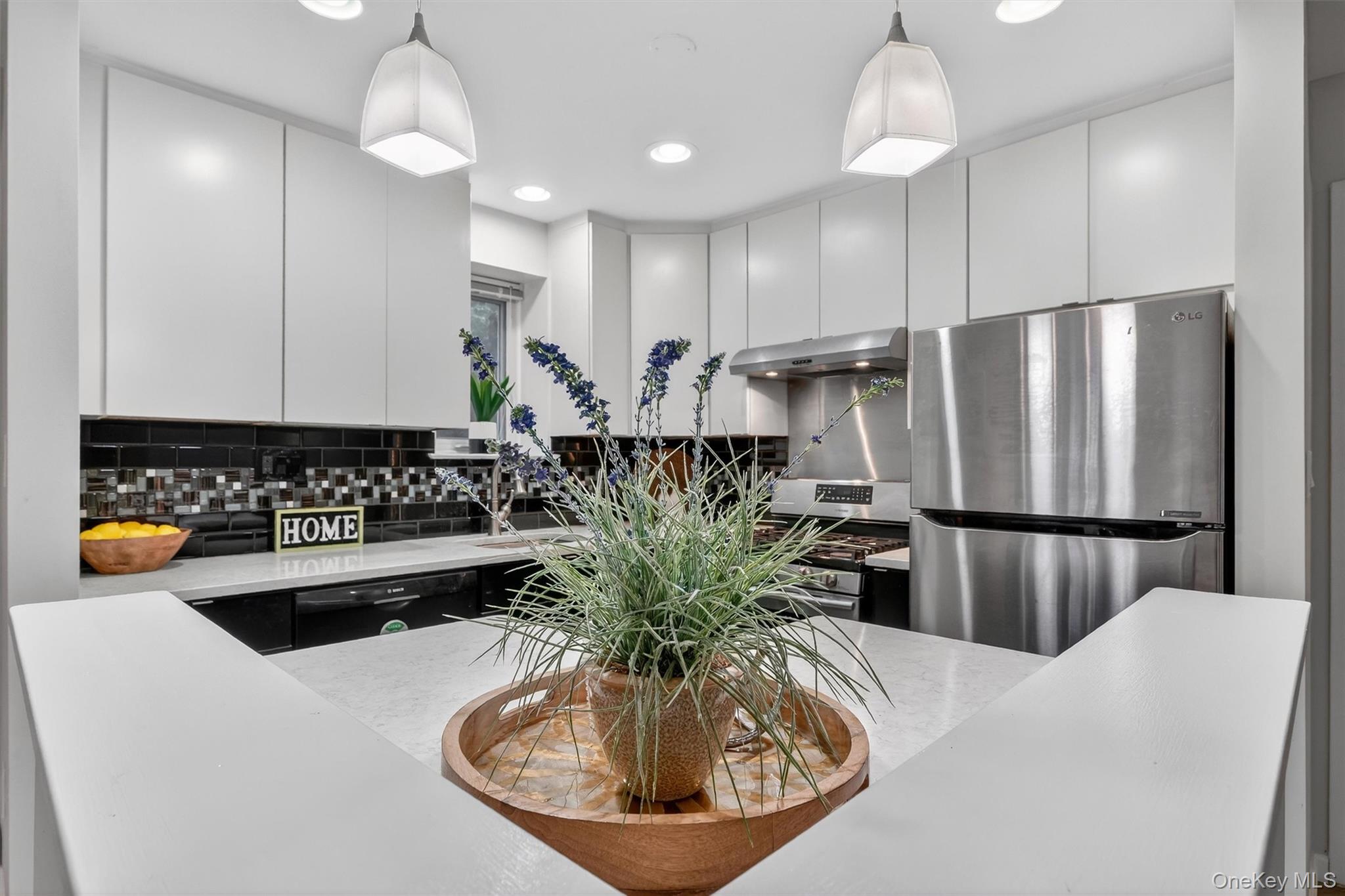 14 Scenic Drive, Unit 14T Croton-on-Hudson, NY 10520 - Photo 10 of 29 a kitchen with stainless steel appliances granite countertop a refrigerator a sink a stove and a dining table
