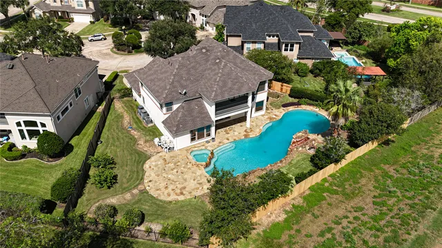 an aerial view of multiple houses with yard