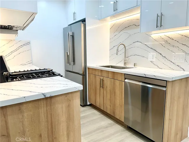 a kitchen with a sink and a refrigerator