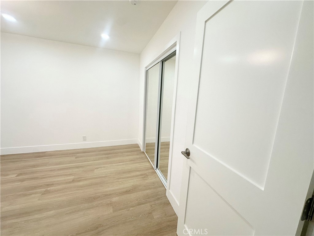 301 Ashland Avenue, Unit 2 Santa Monica, CA 90405 - Photo 11 of 24 a view of a hallway with wooden floor and a ceiling fan