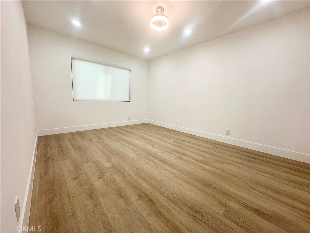 301 Ashland Avenue, Unit 2 Santa Monica, CA 90405 - Photo 17 of 24 an empty room with wooden floor and windows