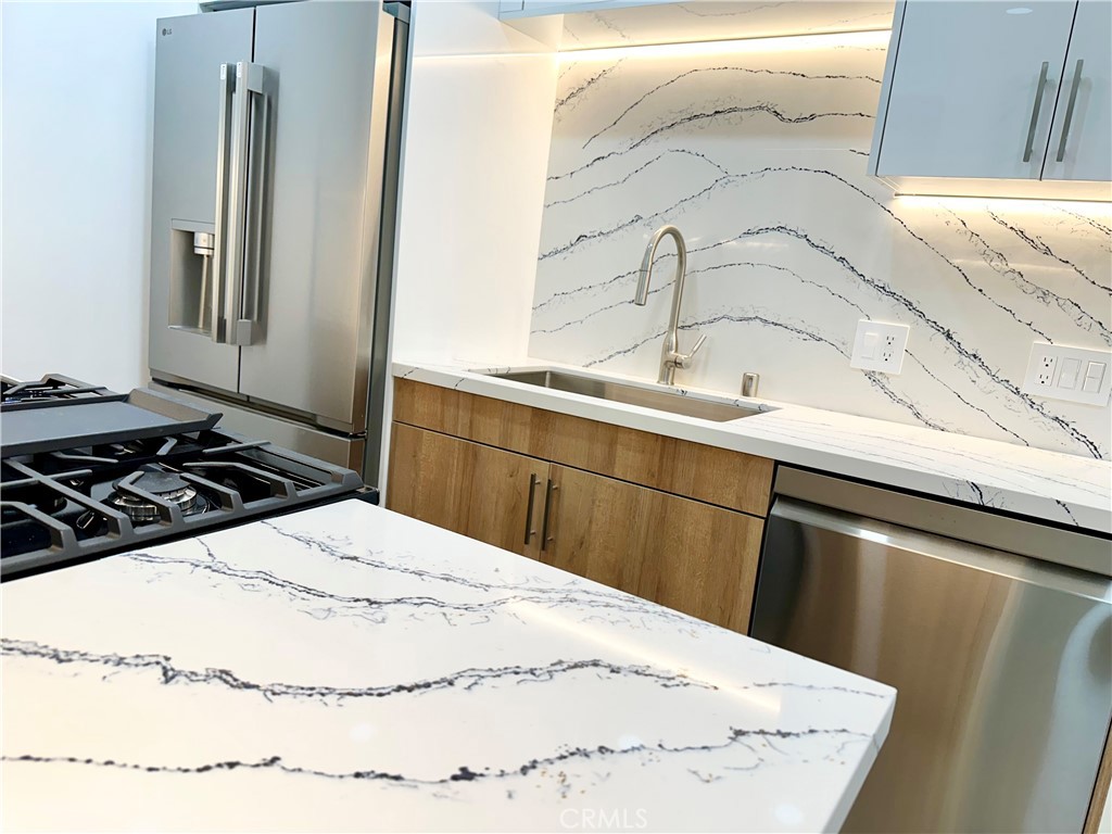 301 Ashland Avenue, Unit 2 Santa Monica, CA 90405 - Photo 5 of 24 a kitchen with a sink a stove and refrigerator
