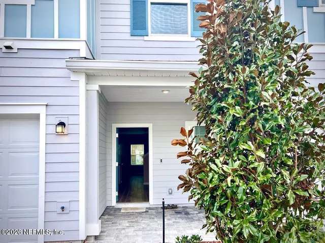 a view of front door and small plants