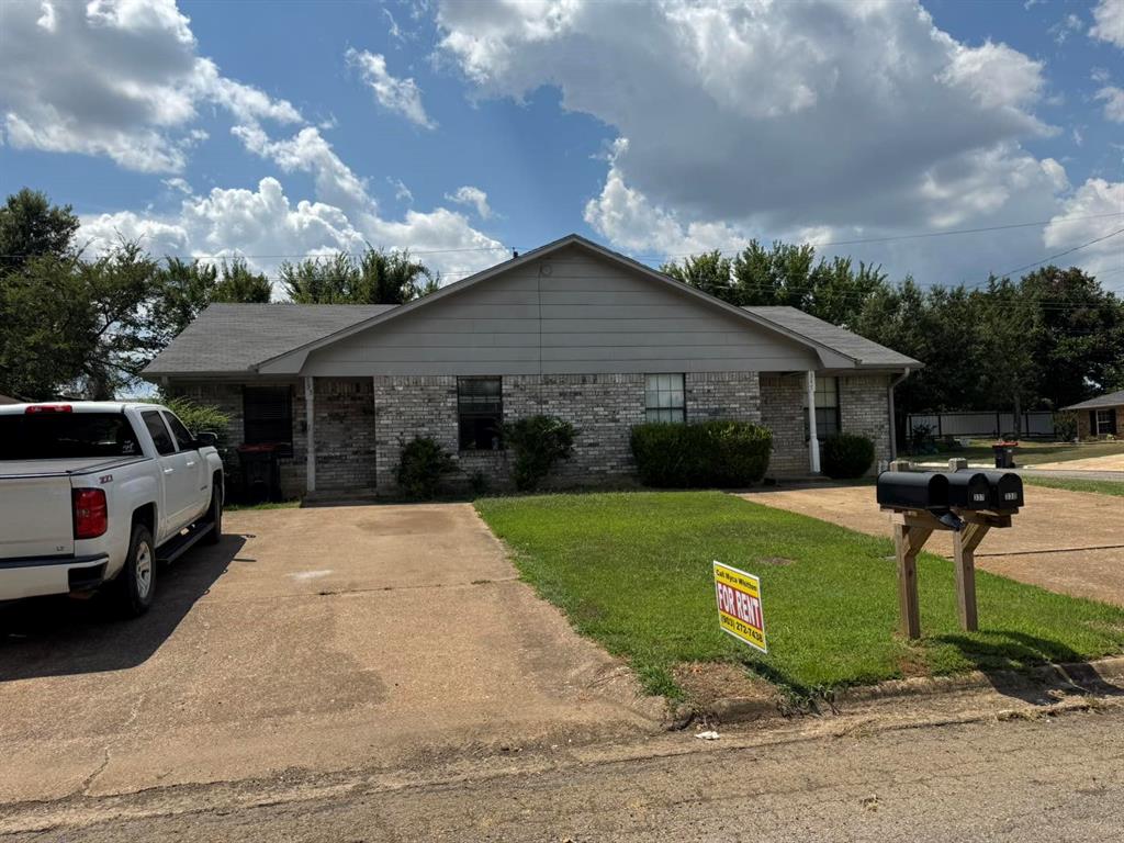 4515 Southeast Loop 286 Paris, TX 75460 - Photo 7 of 37 a front view of a house with a garden and yard