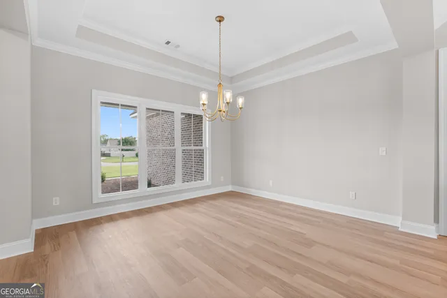 a view of a room with window and wooden floor
