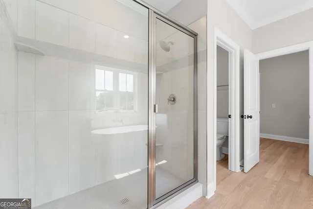 a bathroom with a glass shower door