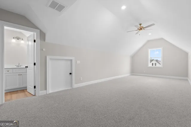 an empty room with a ceiling fan and a window