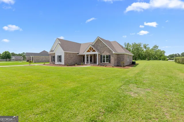a front view of a house with garden
