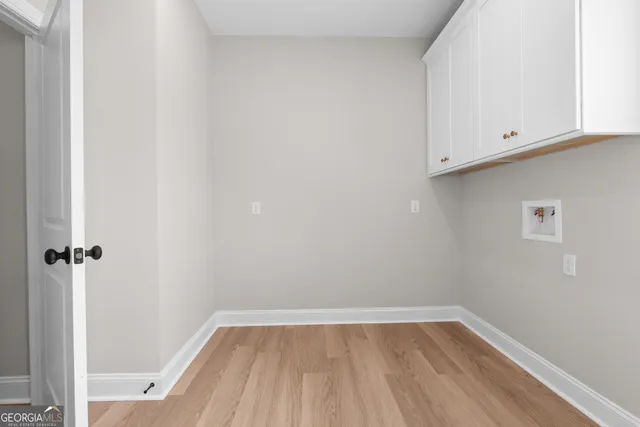 a view of a room with wooden floor and cabinet
