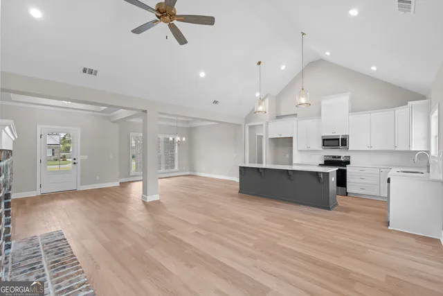 a view of kitchen with cabinets and wooden floor