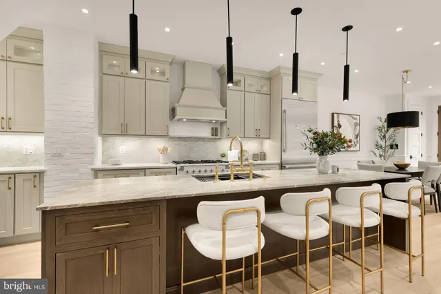 a kitchen with granite countertop a sink a stove and cabinets