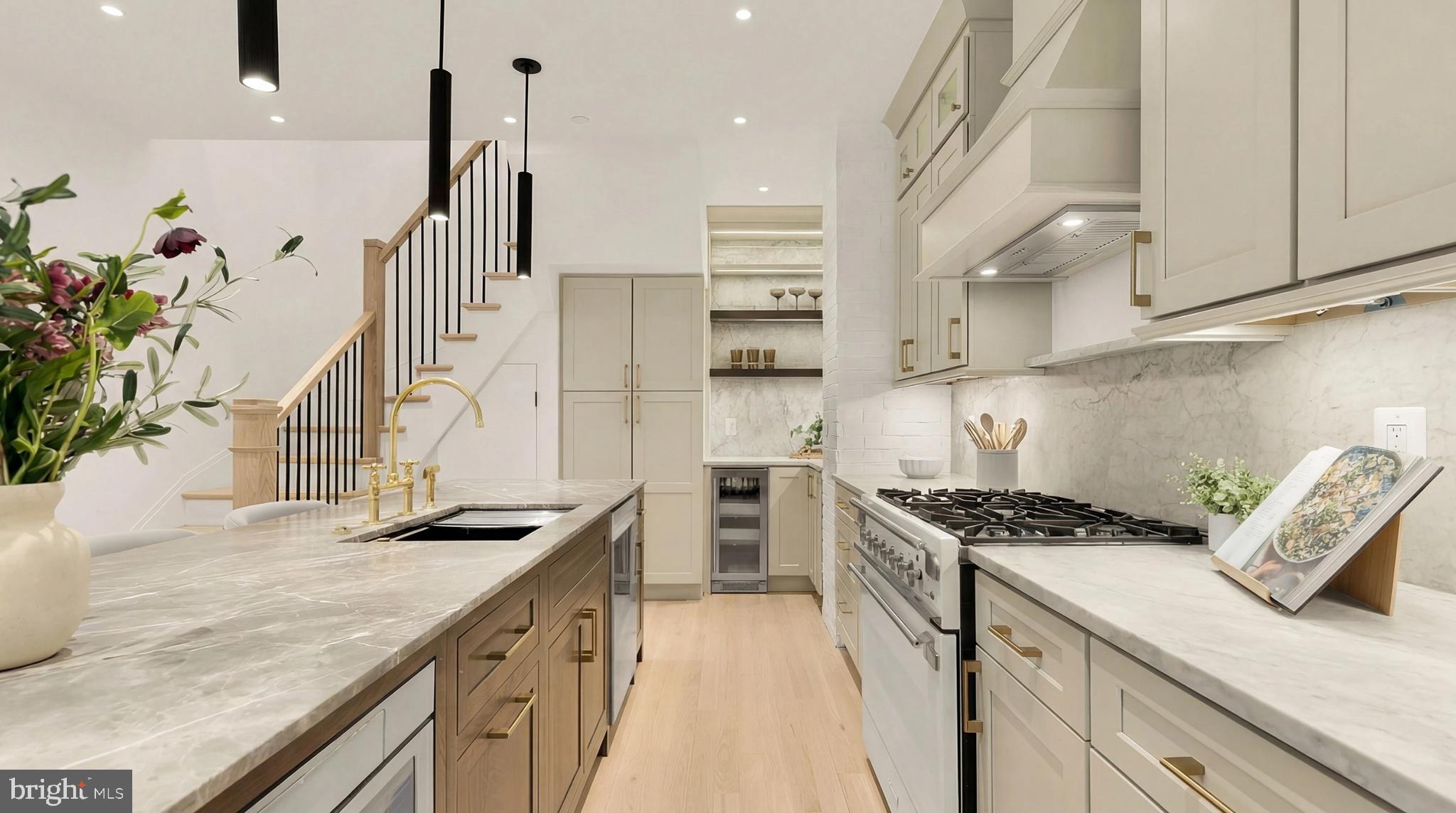 1249 4th Street Northwest Washington, DC 20001 - Photo 14 of 32 a kitchen with stainless steel appliances granite countertop a sink a stove and a wooden floors
