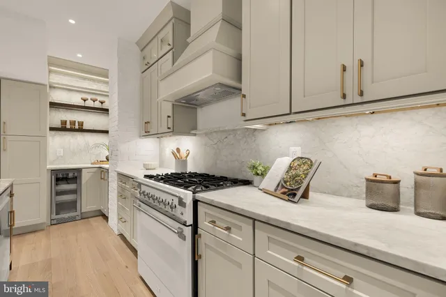 a kitchen with stainless steel appliances granite countertop a kitchen island a stove and a sink