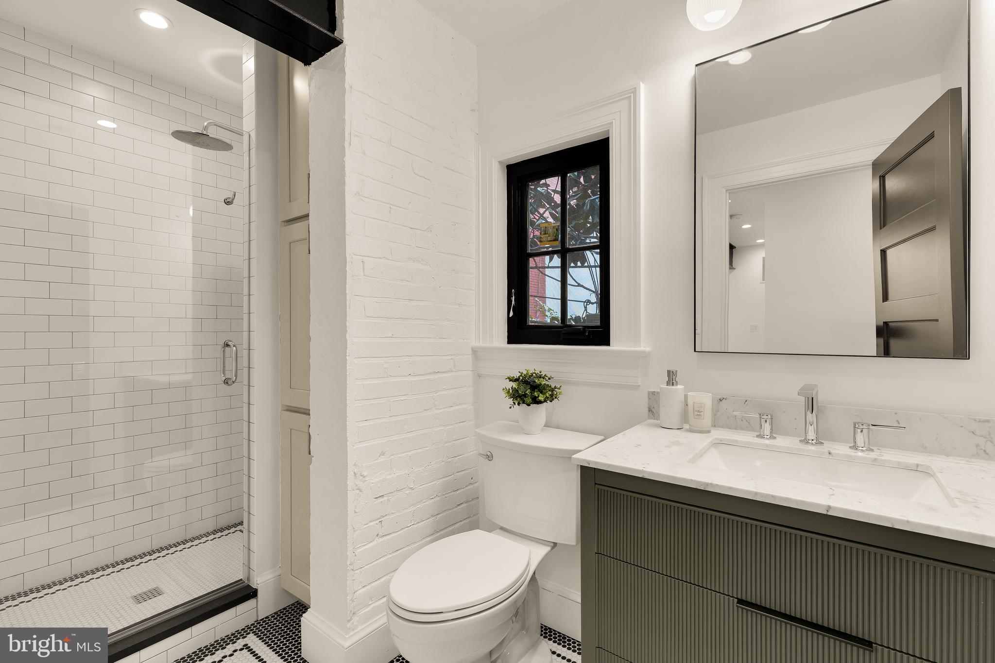 1249 4th Street Northwest Washington, DC 20001 - Photo 22 of 32 a bathroom with a sink a toilet and shower
