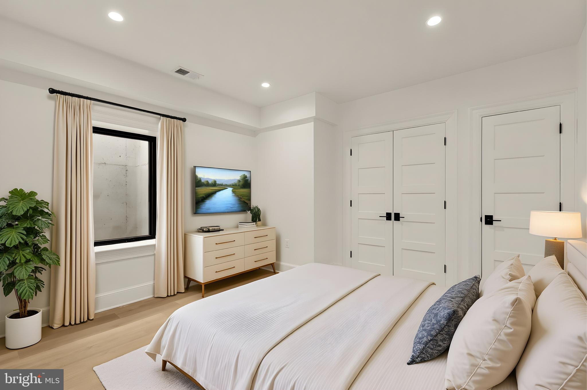 1249 4th Street Northwest Washington, DC 20001 - Photo 28 of 32 a bedroom with a bed and a potted plant