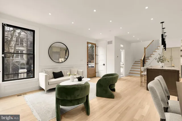 a living room with furniture and a dining table