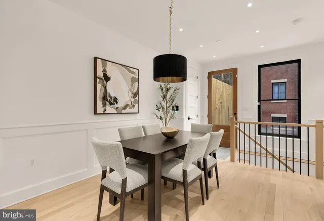 a living room with furniture a large window and a chandelier