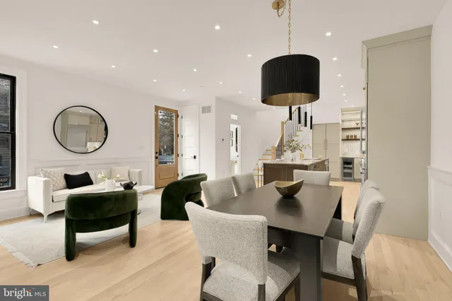 a dining table chairs and a chandelier