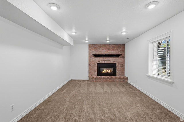 358 West 1200th Street North Mapleton, UT 84664 - Photo 22 of 30 Spacious living room featuring gas fireplace, new carpeting, and new paint and lighting.