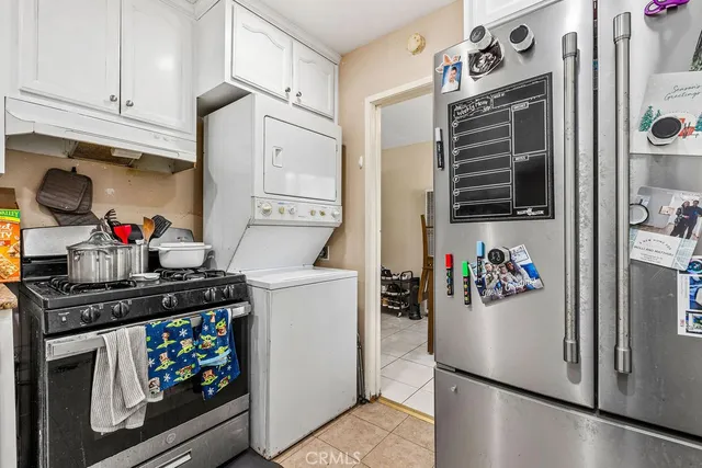 a kitchen with stainless steel appliances granite countertop a refrigerator and a stove