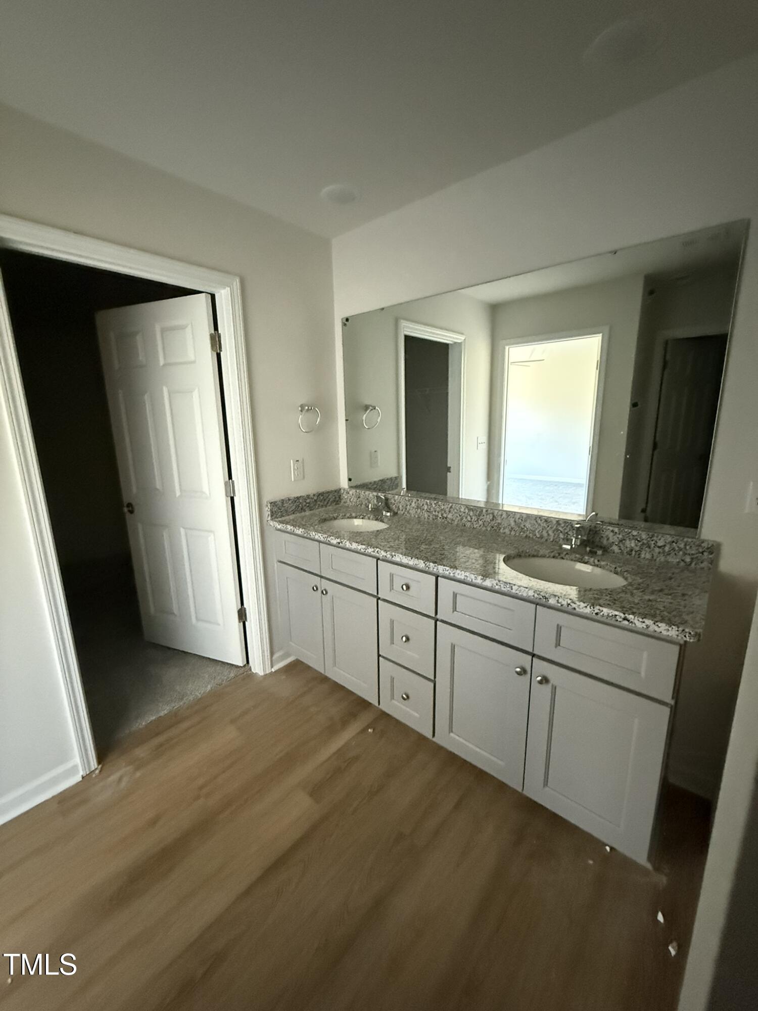 186 Phil Jack Road Dunn, NC 28334 - Photo 11 of 16 a spacious bathroom with a granite countertop sink and a mirror