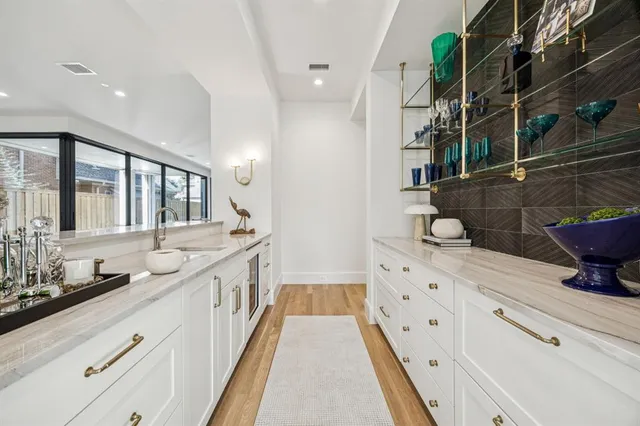 a bathroom with a granite countertop sink and a large mirror