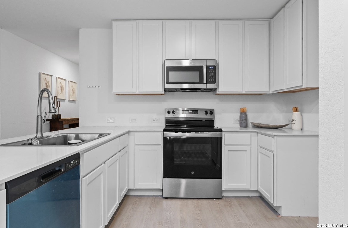 3849 High Tide Seguin, TX 78155 - Photo 6 of 15 a kitchen with stainless steel appliances granite countertop a sink and a stove