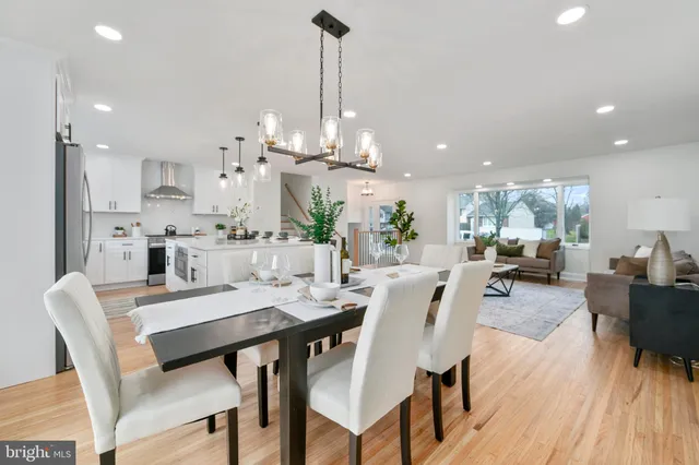 a dining room with furniture a chandelier and wooden floor