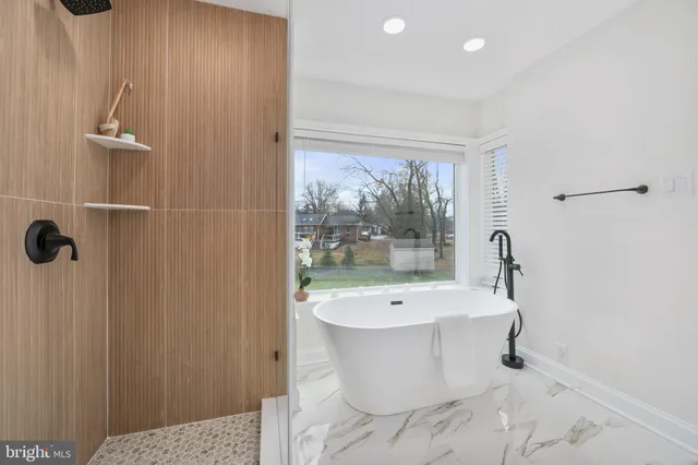 a bathroom with a bathtub and shower