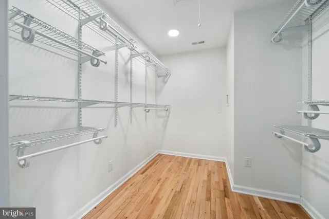 a view of a room with wooden floor and white walls