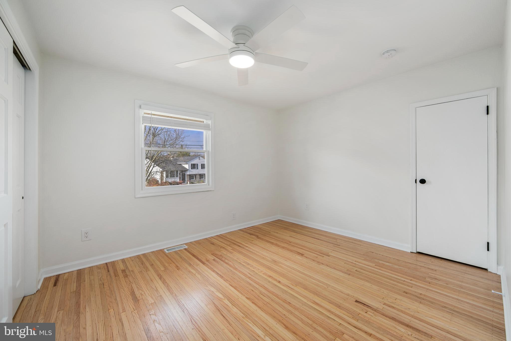 308 Farmdale Road Moorestown, NJ 08057 - Photo 29 of 47 an empty room with wooden floor and windows
