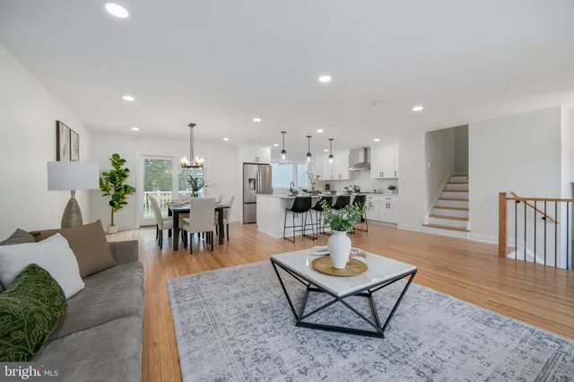 a living room with furniture kitchen view and a dining table