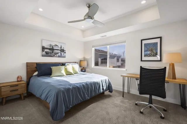 a spacious bedroom with a bed and a couch