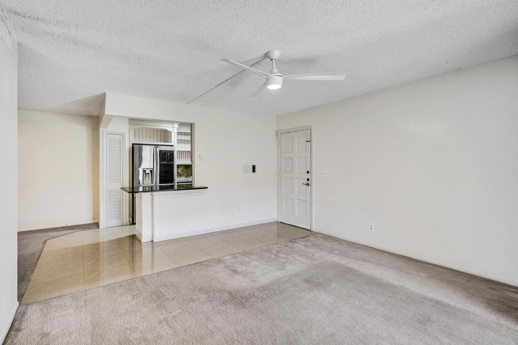 1050 Northwest 13th Street, Unit 193D Boca Raton, FL 33486 - Photo 11 of 55 an empty room with kitchen and windows