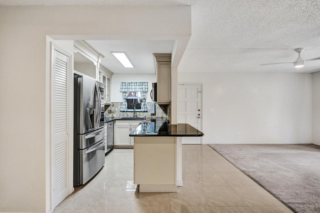 1050 Northwest 13th Street, Unit 193D Boca Raton, FL 33486 - Photo 13 of 55 a kitchen with cabinets and stainless steel appliances