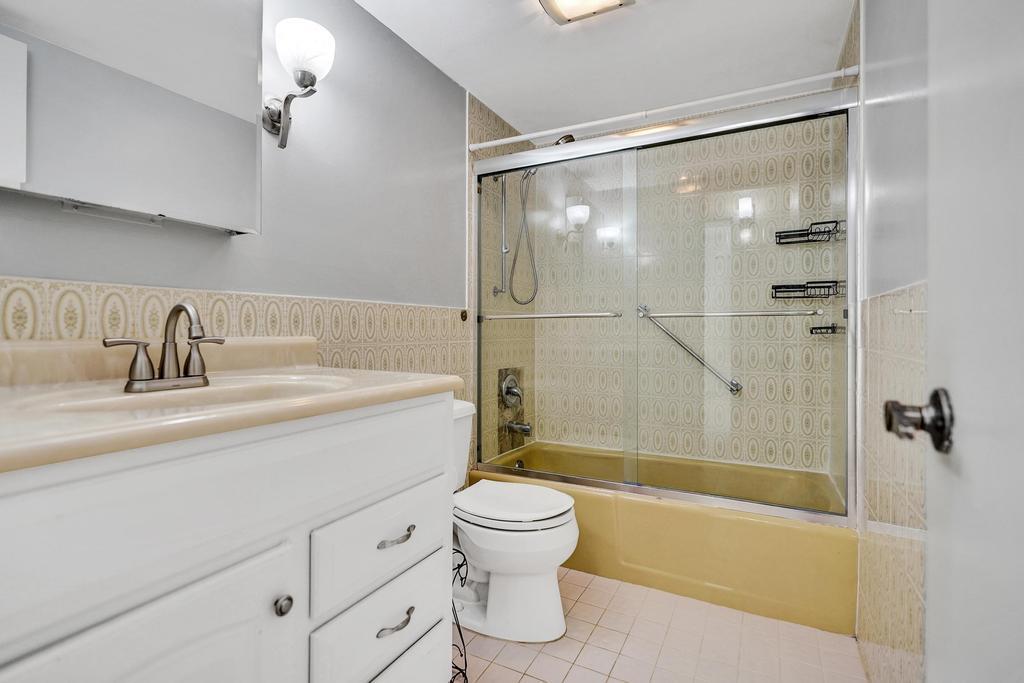 1050 Northwest 13th Street, Unit 193D Boca Raton, FL 33486 - Photo 17 of 55 a bathroom with a sink toilet and shower