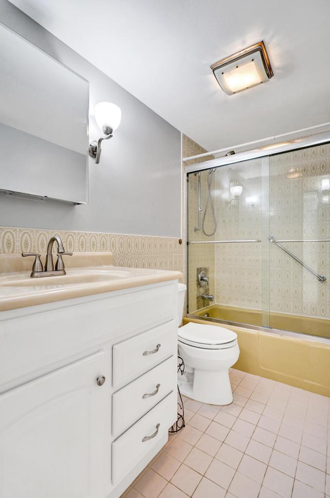 1050 Northwest 13th Street, Unit 193D Boca Raton, FL 33486 - Photo 18 of 55 a bathroom with a sink toilet and shower