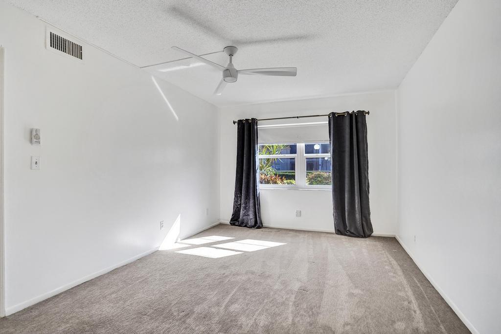 1050 Northwest 13th Street, Unit 193D Boca Raton, FL 33486 - Photo 22 of 55 wooden floor and window in an empty room
