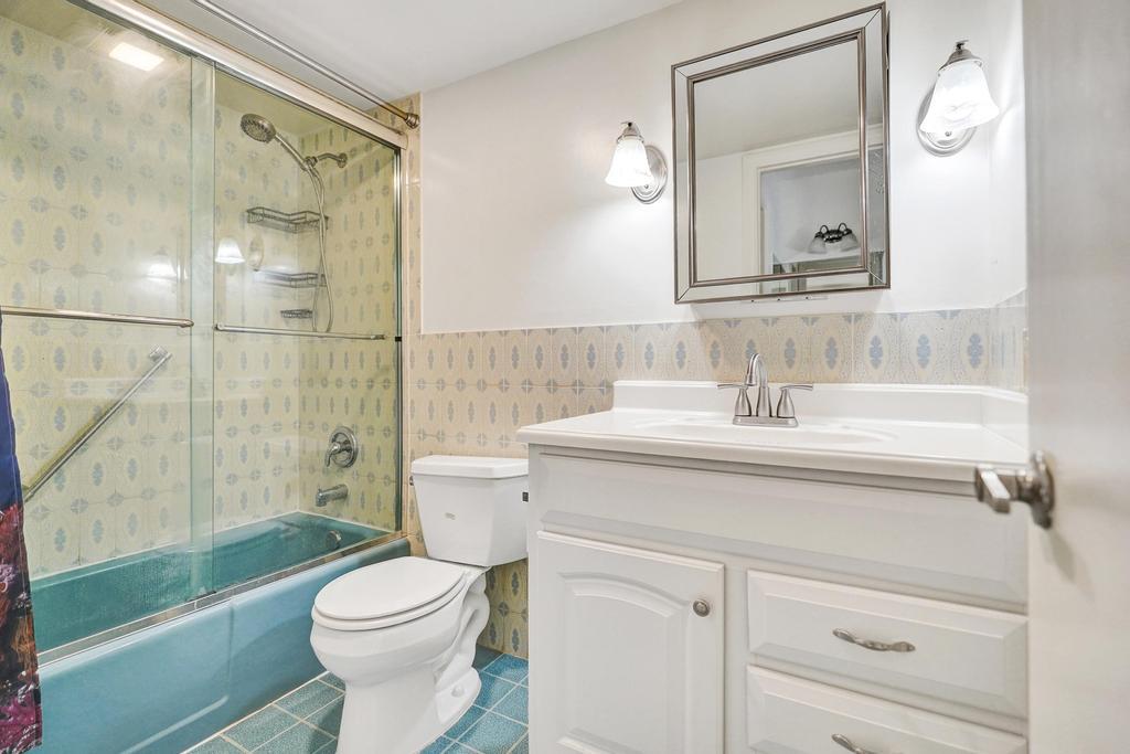 1050 Northwest 13th Street, Unit 193D Boca Raton, FL 33486 - Photo 27 of 55 a bathroom with a sink a toilet and shower