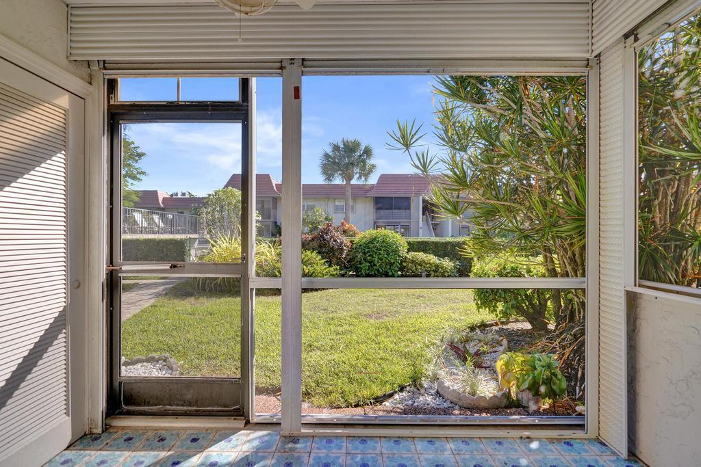1050 Northwest 13th Street, Unit 193D Boca Raton, FL 33486 - Photo 29 of 55 a view of a glass door and a yard