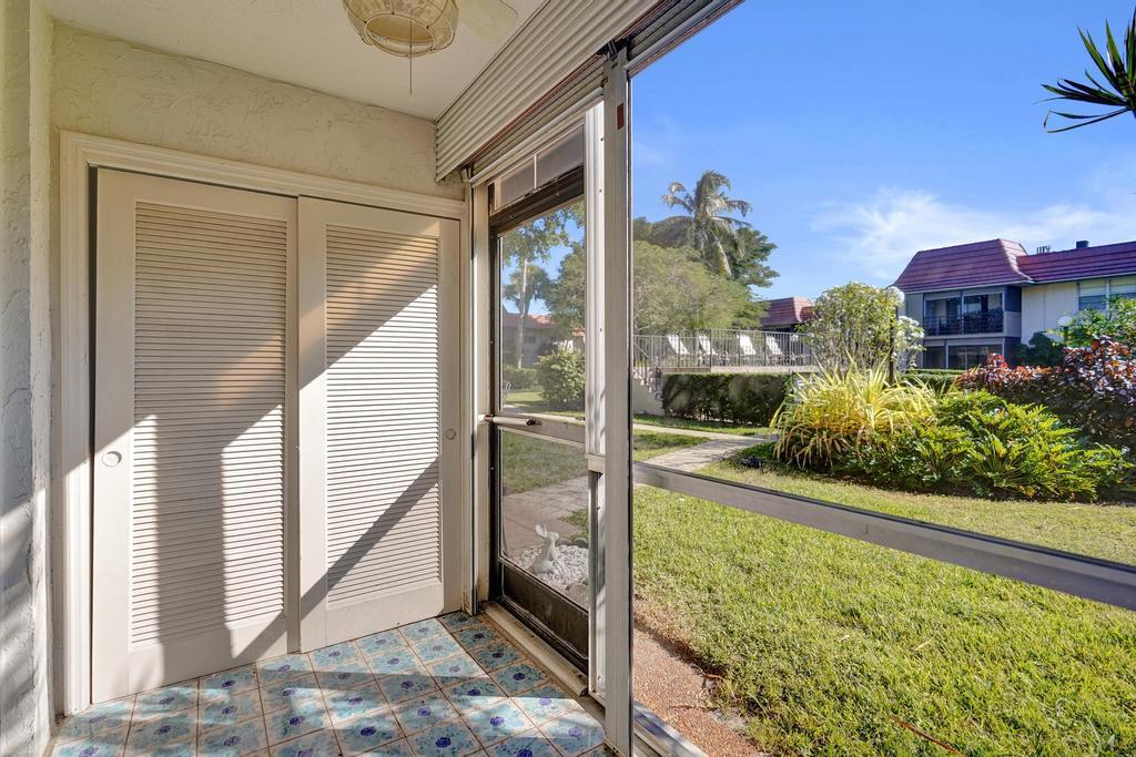 1050 Northwest 13th Street, Unit 193D Boca Raton, FL 33486 - Photo 30 of 55 a view of a porch and garden