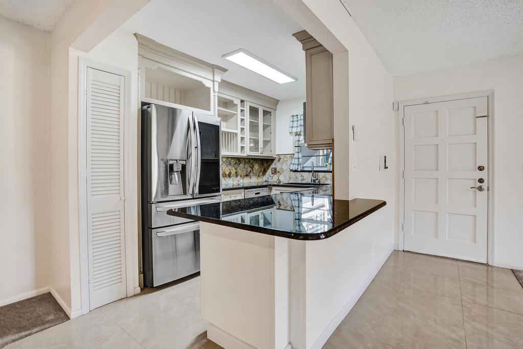 1050 Northwest 13th Street, Unit 193D Boca Raton, FL 33486 - Photo 3 of 55 a kitchen with stainless steel appliances granite countertop a sink stove and refrigerator