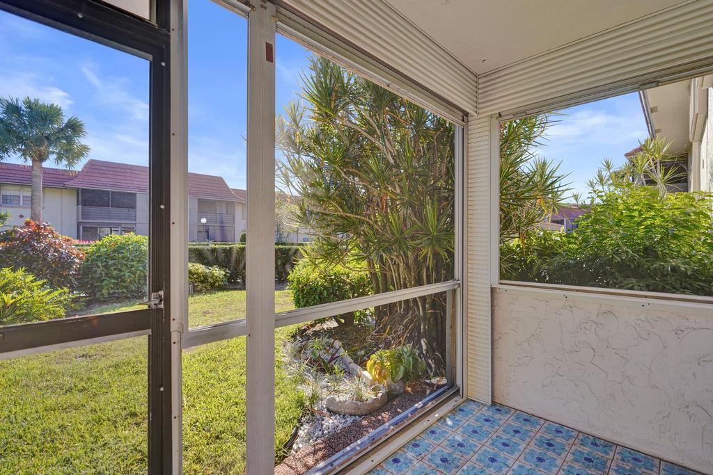 1050 Northwest 13th Street, Unit 193D Boca Raton, FL 33486 - Photo 31 of 55 a view of a porch with a floor to ceiling window and wooden floor