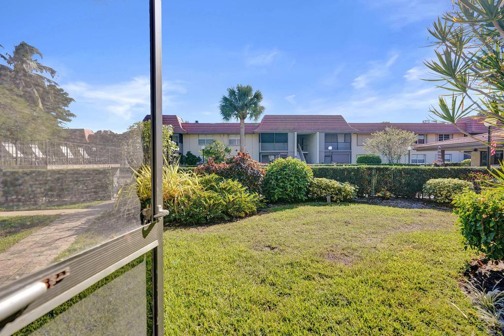 1050 Northwest 13th Street, Unit 193D Boca Raton, FL 33486 - Photo 32 of 55 a view of a garden with a building in the background